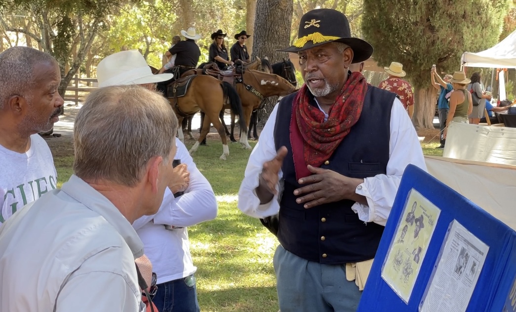 Trooper William Terrell speaks with park visitors at Peña Adobe!